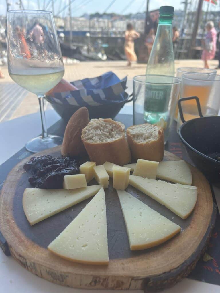 Basque cheese board with bread and wine in San Sebastián