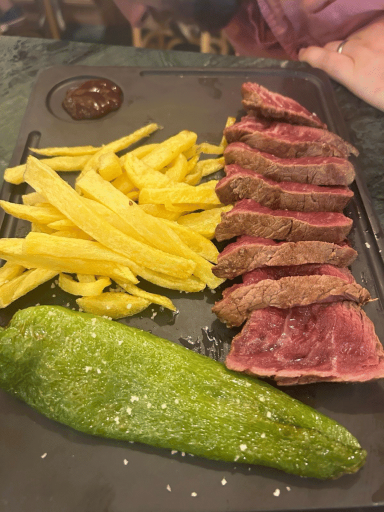 Steak with chips and grilled pepper at Bodeguitas Antonio Romero in Seville