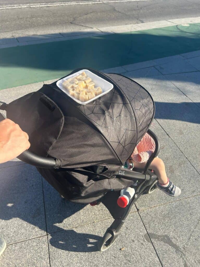 Cheese snack on our Silver Cross Clic pushchair while exploring Seville with our toddler