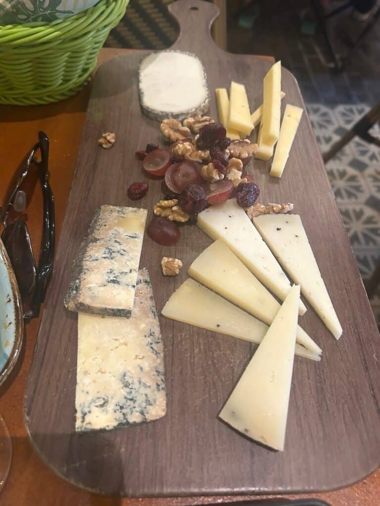 Cheese board with grapes and walnuts at El Librero in Seville