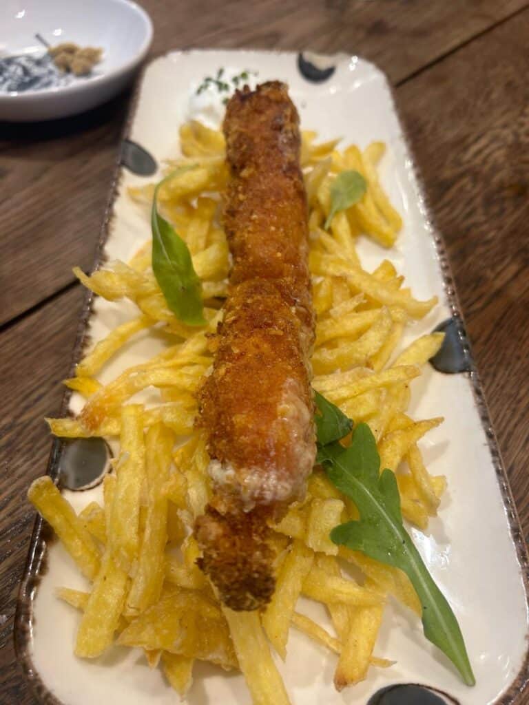 Breaded meat dish with fries at Pan y Circo in Seville