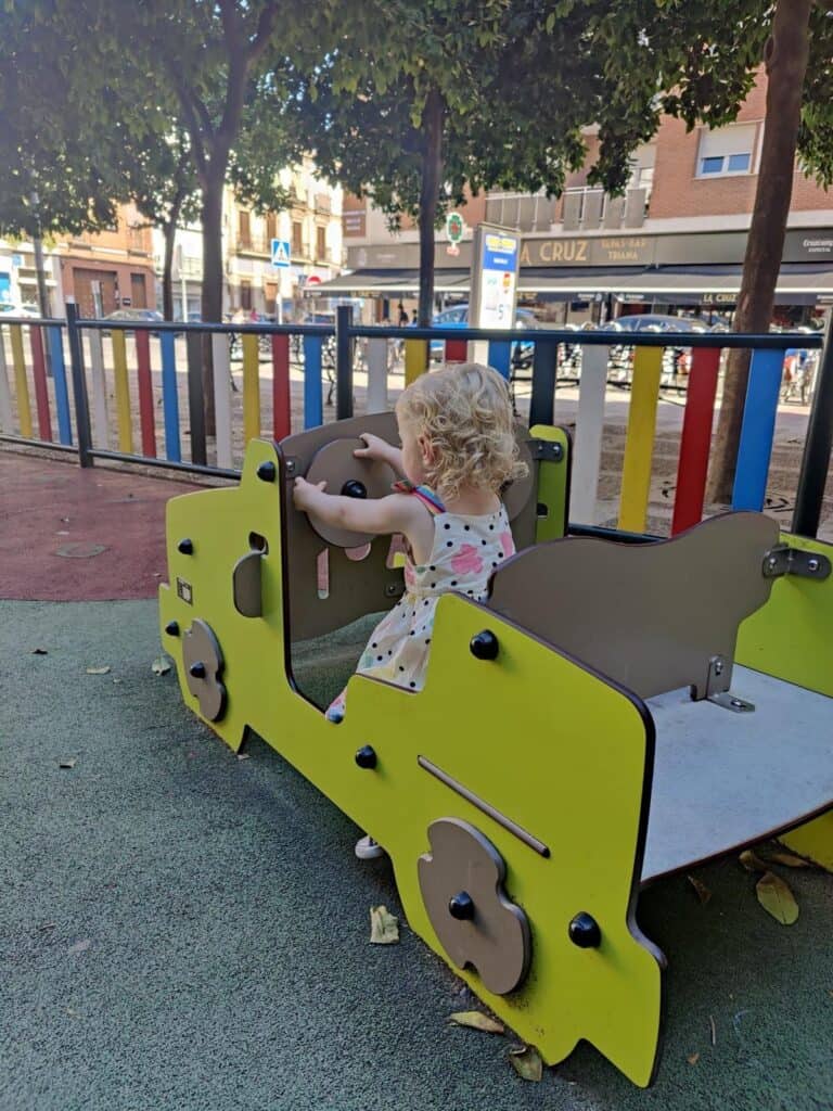 Our toddler playing in a playground in Seville
